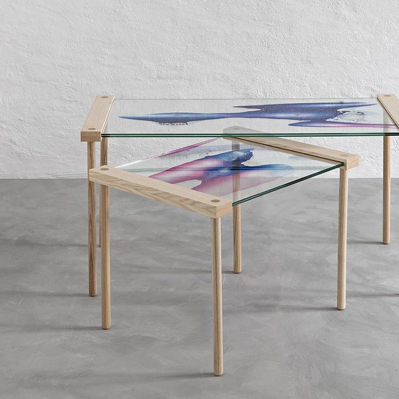 Contemporary side table that press contents between glass sheets, designed by Stoft