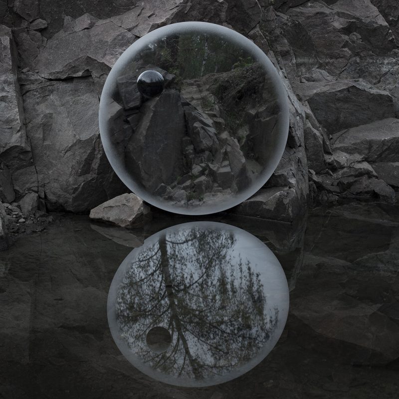 A contemporary round steel mirror with a crafted black diabase stone creating an optical illusion, designed by Stoft